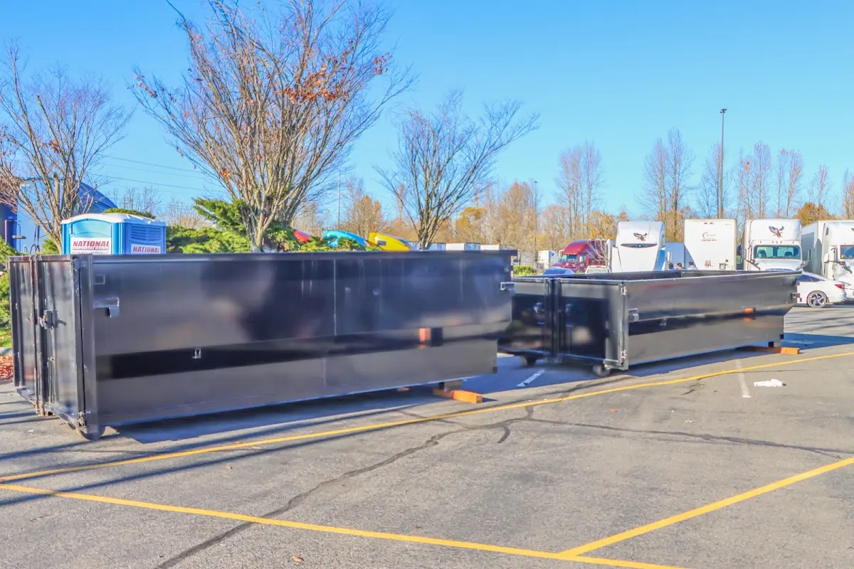 Professional dumpster rental service with roll-off container on residential driveway in Clifton